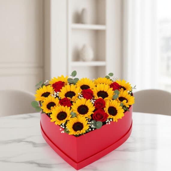 Arreglo Floral RINA: Corazón de Girasoles y Rosas Rojas para Regalar Arreglo floral RINA en forma de corazón con girasoles vibrantes y rosas rojas, ideal para expresar amor y alegría en cualquie