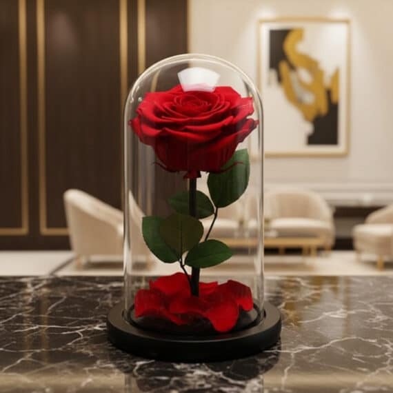 Rosa Preservada Roja en Cúpula de Cristal: Regalo Eterno y Elegante Rosa preservada roja en cúpula de cristal sobre una mesa de mármol negro, con un fondo elegante de lobby de hotel boutique.